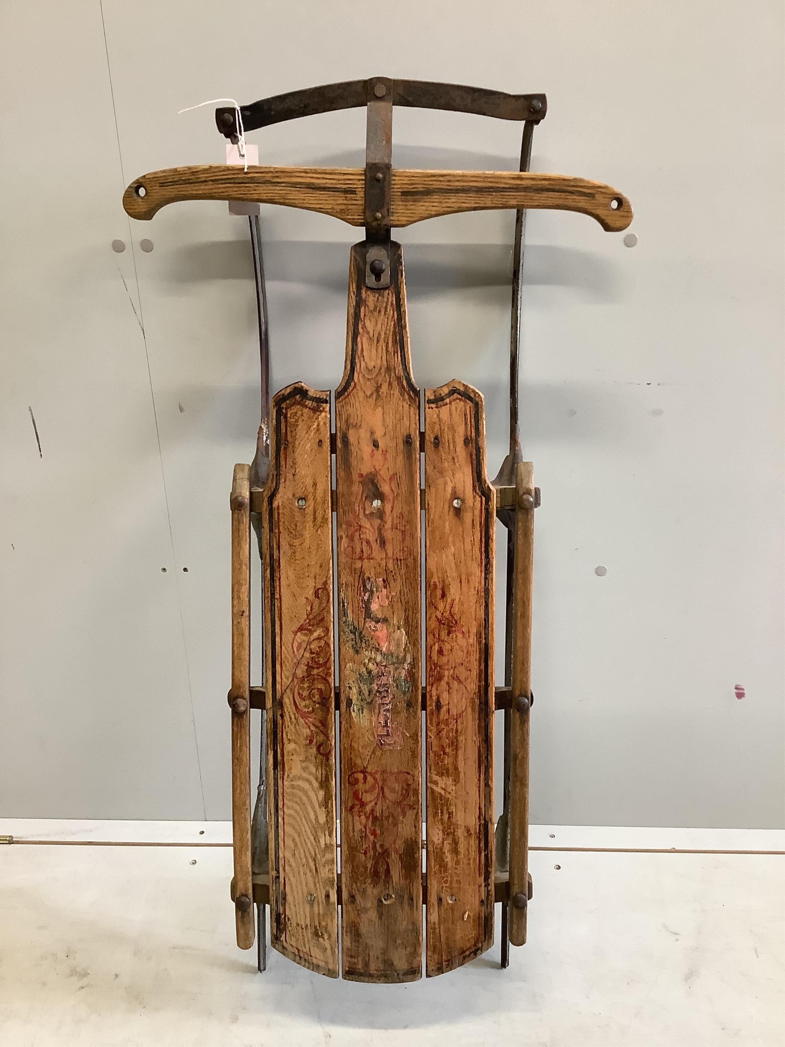 A painted sledge, width 53cm, depth 107cm, height 17cm